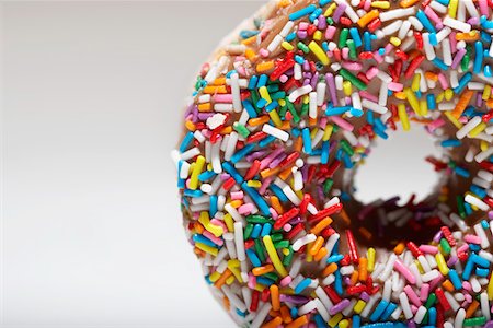 sprinkles - Rainbow sprinkles on doughnut Stock Photo - Premium Royalty-Free, Code: 693-03312113