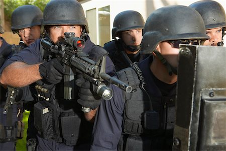 Swat officers aiming guns Stock Photo - Premium Royalty-Free, Code: 693-03312332