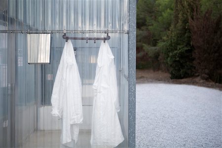 Lab coats hanging in plastic change room Stock Photo - Premium Royalty-Free, Code: 693-03312748