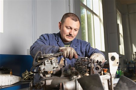 Mechanic Working on Motor Stock Photo - Premium Royalty-Free, Code: 693-03313189