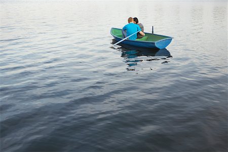 Young Couple Cuddling in Rowboat on Lake Stock Photo - Premium Royalty-Free, Code: 693-03313293