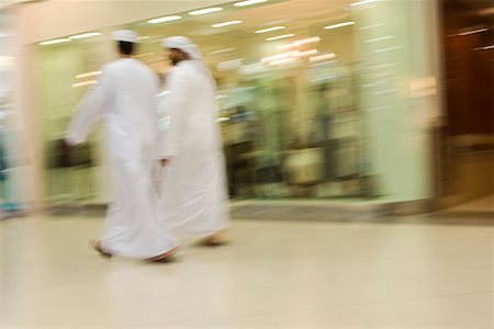 Dubai, UAE, Two men traditionally dressed in dishdashs and gutras, white robes and headdresses. Stock Photo - Premium Royalty-Free, Code: 693-03313664