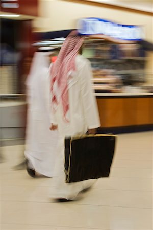 Dubai, UAE, Two men traditionally dressed in dishdashs and gutras, white robes and headdresses. Stock Photo - Premium Royalty-Free, Code: 693-03313665