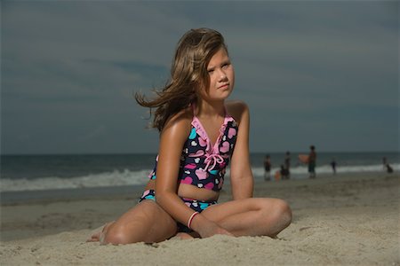 preteen girls at beach - Little Girl Sitting on a Beach Stock Photo - Premium Royalty-Free, Code: 693-03313969