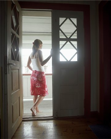 picture of open door of home - Woman standing in open door,  Looking Out, back view Stock Photo - Premium Royalty-Free, Code: 693-03363670