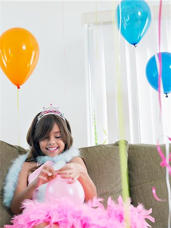 simsearch:693-03305634,k - Young girl (7-9) on sofa preparing birthday balloons Stock Photo - Premium Royalty-Free, Code: 693-03363687