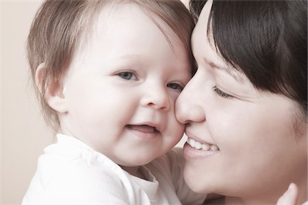 Mother squashes her nose against toddlers face Stock Photo - Premium Royalty-Free, Code: 693-03440779