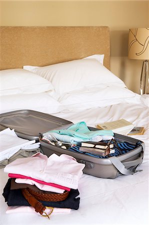 simsearch:693-07672717,k - Stacks of folded clothes and packed Suitcase on Bed Stock Photo - Premium Royalty-Free, Code: 693-03556953