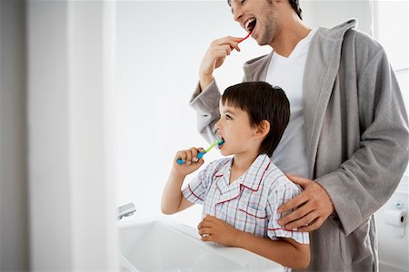 Father and Son Brushing Teeth in bathroom Stock Photo - Premium Royalty-Free, Code: 693-03557240