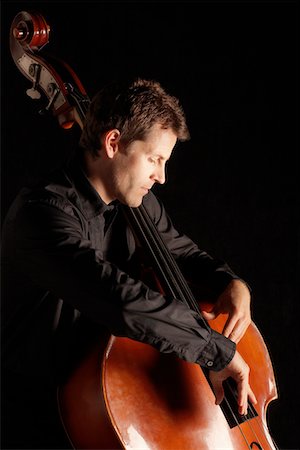stringed instruments black background - Man Playing Double Bass, side view Stock Photo - Premium Royalty-Free, Code: 693-03557268