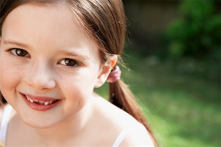 Little Girl sitting in backyard, portrait, close up Stock Photo - Premium Royalty-Free, Code: 693-03564911