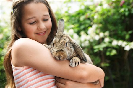 pet owners and their pets - Girl Holding Rabbit Stock Photo - Premium Royalty-Free, Code: 693-03565028