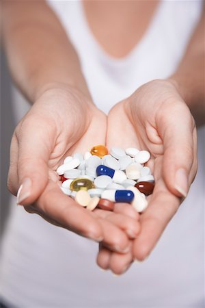 suicide - Woman holding pills in hands, close-up on hands Stock Photo - Premium Royalty-Free, Code: 693-03565242