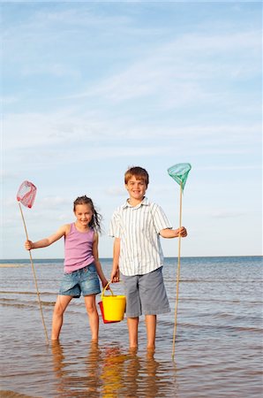 fishnet - Girl and Boy Playing at Beach Stock Photo - Premium Royalty-Free, Code: 693-03565418