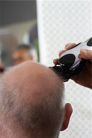 Barber shaving mans head in barber shop, close-up Stock Photo - Premium Royalty-Free, Code: 693-03565754