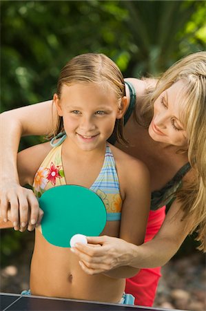 Mother teaching daughter (5-7) to play ping-pong, outdoors. Stock Photo - Premium Royalty-Free, Code: 693-03706939