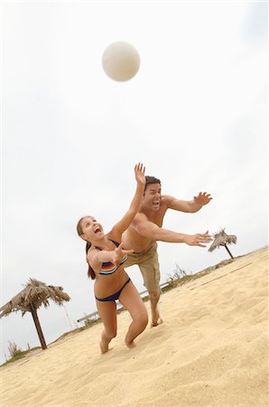 diving (not water) - Couple Diving for Volleyball on Beach, tilt view Stock Photo - Premium Royalty-Free, Code: 693-03707018