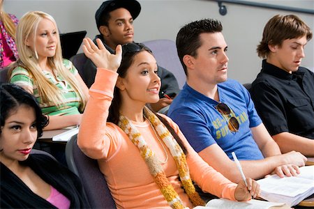 Student raising hand during class lecture Stock Photo - Premium Royalty-Free, Code: 693-03707053