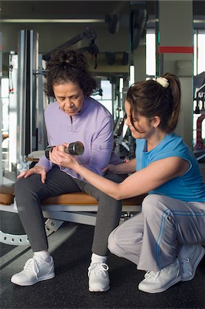 simsearch:693-06018275,k - Trainer Assisting Senior Woman in Weightlifting With Dumbbell Stock Photo - Premium Royalty-Free, Code: 693-03707265
