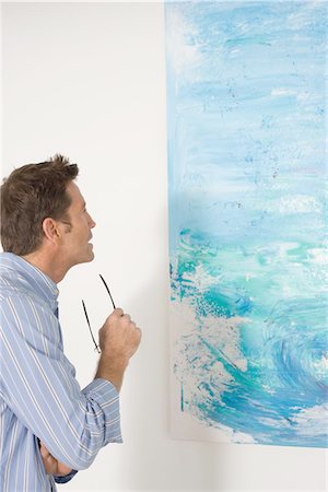 simsearch:693-05552760,k - Man contemplating paintings in gallery Stock Photo - Premium Royalty-Free, Code: 693-03707413