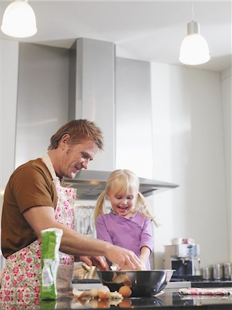 Father and Daughter Cooking in Kitchen Stock Photo - Premium Royalty-Free, Code: 693-03707536