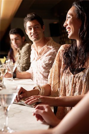 Mid-adult People standing at Bar with cocktail glasses, socializing Stock Photo - Premium Royalty-Free, Code: 693-03707561