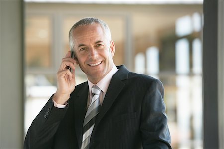simsearch:400-05366591,k - Businessman Using Cell Phone Stock Photo - Premium Royalty-Free, Code: 693-03707833