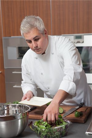 Mid- adult chef prepares salad Stock Photo - Premium Royalty-Free, Code: 693-03782514