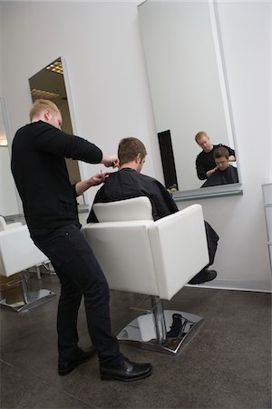 Unisex hairdresser,male client has his hair cut Stock Photo - Premium Royalty-Free, Code: 693-03782585