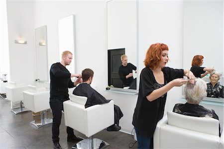 stylist - Stylists cut clients' hair in unisex salon Stock Photo - Premium Royalty-Free, Code: 693-03782589