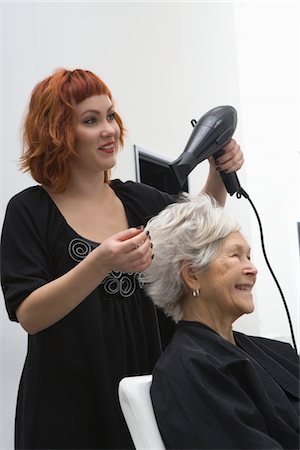 Stylist blow-drys elderly woman's hair Stock Photo - Premium Royalty-Free, Code: 693-03782595