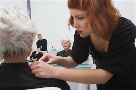 Stylist makes finishing touches to elderly woman's hair Stock Photo - Premium Royalty-Free, Code: 693-03782597