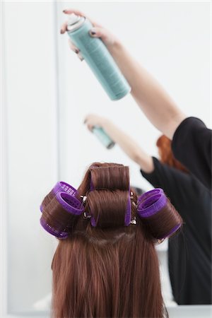 Stylist sprays head of hair with rollers Stock Photo - Premium Royalty-Free, Code: 693-03782611