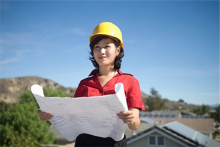 simsearch:693-03643971,k - A business lady on a rooftop with plans in her hand Stock Photo - Premium Royalty-Free, Code: 693-03782698