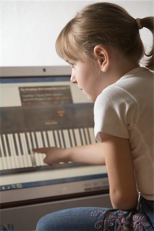 Child leans keywboard on computer with touch screen technology Stock Photo - Premium Royalty-Free, Code: 693-03782860