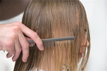 Combing a womans wet hair in the hairdressers Stock Photo - Premium Royalty-Free, Code: 693-03782999