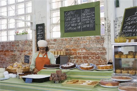 Catering assistant stands in service area of canteen Stock Photo - Premium Royalty-Free, Code: 693-03783156