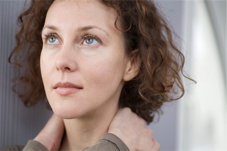 positive thought - Mid adult woman looking up with hands holding neck Stock Photo - Premium Royalty-Free, Code: 693-03783188