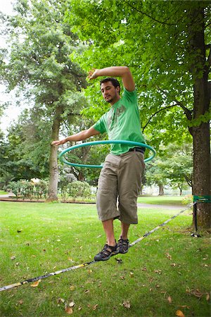 Man on Slackline with Hula Hoop Stock Photo - Rights-Managed, Code: 700-04931676