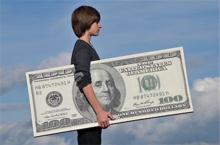 Boy Holding Over-Sized 100 Dollar Bill Stock Photo - Rights-Managed, Code: 700-05662618