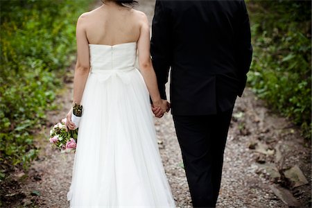 romantic couple holding hands - Backview of Bride and Groom Walking down Footpath, Toronto, Ontario, Canada Stock Photo - Rights-Managed, Code: 700-05756386