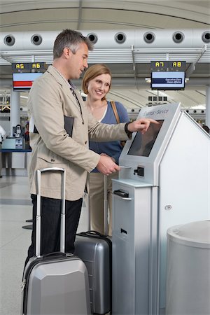 Couple Checking In at Airport Stock Photo - Rights-Managed, Code: 700-05756418