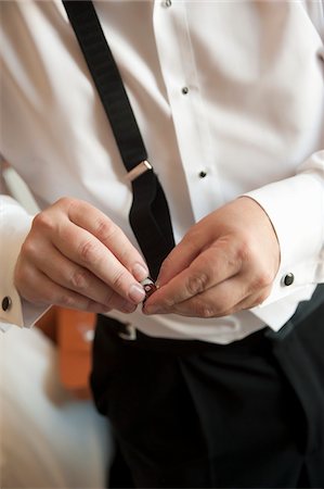 suave - Groom Fastening Suspenders Stock Photo - Rights-Managed, Code: 700-05855118