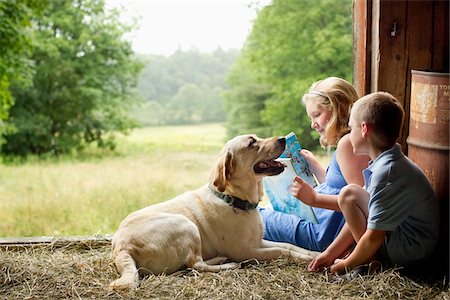 Children Reading in Barn with Dog Stock Photo - Rights-Managed, Code: 700-06009231