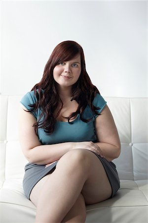 sitting with mini skirt - Portrait of Woman Sitting on Sofa Stock Photo - Rights-Managed, Code: 700-06144798