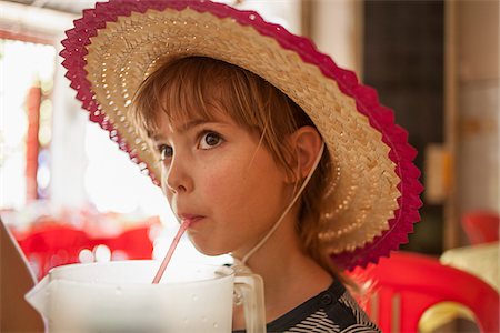 Girl Wearing Hat and Drinking from Straw Stock Photo - Rights-Managed, Code: 700-06199238