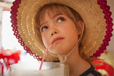 Girl Wearing Straw Hat and Drinking from Straw Stock Photo - Rights-Managed, Code: 700-06199239