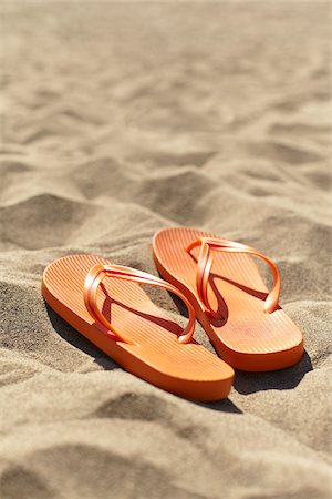 summer holiday shoes - Orange Flip Flops on Beach Stock Photo - Rights-Managed, Code: 700-06334549