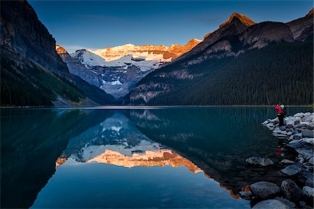 Person Standing on Rocky Shore of Lake Louise at Dawn, Banff National Park, Alberta, Canada Stock Photo - Rights-Managed, Code: 700-06465422