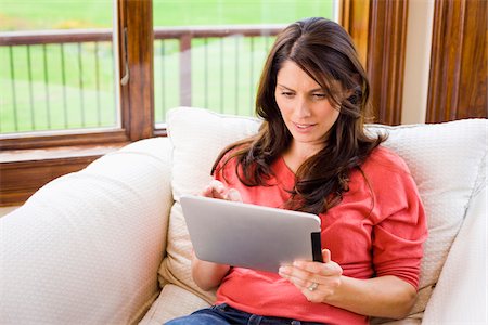 single woman sitting on a chair home - Woman Holding iPad at Home Stock Photo - Rights-Managed, Code: 700-06645604